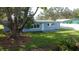 Updated light blue house exterior, backyard view at 1042 Idlewild N Dr, Dunedin, FL 34698
