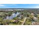 Aerial view of the property and surrounding neighborhood near a lake at 12011 N Gomez Ave, Tampa, FL 33618