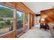 Living room with wood paneled walls and view of the front entry at 12011 N Gomez Ave, Tampa, FL 33618