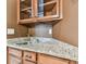 Wet bar with granite countertop and wood cabinets at 12709 Mannhurst Oak Ln, Lithia, FL 33547