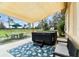 Relaxing hot tub area with covered patio, outdoor seating, and lush landscaping at 12709 Mannhurst Oak Ln, Lithia, FL 33547