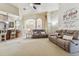 Open living room with comfortable seating and views into kitchen and dining areas at 12709 Mannhurst Oak Ln, Lithia, FL 33547