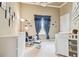 Bright Bedroom featuring a crib, rocker, and ample storage at 12709 Mannhurst Oak Ln, Lithia, FL 33547