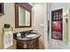 Powder room with dark vanity and a modern sink at 12709 Mannhurst Oak Ln, Lithia, FL 33547