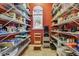 Well-organized pantry with ample shelving for food storage at 12709 Mannhurst Oak Ln, Lithia, FL 33547