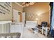 Bedroom with crib, dresser, and comfortable rocking chair at 12709 Mannhurst Oak Ln, Lithia, FL 33547