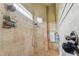 Spacious shower with tile surround and multiple shower heads at 12709 Mannhurst Oak Ln, Lithia, FL 33547