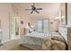 Spacious bedroom with view, ceiling fan, and en-suite bathroom at 12709 Mannhurst Oak Ln, Lithia, FL 33547