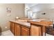 Wet bar with wood cabinets and granite countertop at 12709 Mannhurst Oak Ln, Lithia, FL 33547