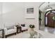 Sitting area with two chairs and a glass-top coffee table at 12709 Mannhurst Oak Ln, Lithia, FL 33547