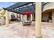 Covered patio with pergola, outdoor dining area, and lush landscaping at 12709 Mannhurst Oak Ln, Lithia, FL 33547
