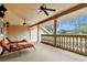 Relaxing balcony with two lounge chairs and a view of the backyard at 12709 Mannhurst Oak Ln, Lithia, FL 33547