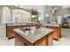 Large kitchen island with granite countertops and a built-in sink at 12709 Mannhurst Oak Ln, Lithia, FL 33547