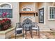 Small patio seating area with table and chairs near a fountain at 12709 Mannhurst Oak Ln, Lithia, FL 33547