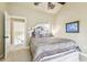 Bedroom with plush bedding and access to balcony at 12709 Mannhurst Oak Ln, Lithia, FL 33547
