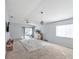 Spacious living room featuring a ceiling fan and sliding glass doors leading to a patio at 12916 Fieldmoor Ct, Riverview, FL 33569