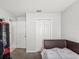 Simple bedroom with a bed, double door closet and additional door at 12916 Fieldmoor Ct, Riverview, FL 33569