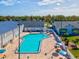 Community swimming pool with surrounding patio and seating at 12916 Fieldmoor Ct, Riverview, FL 33569