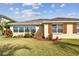 Tan house with brown shutters and manicured lawn at 13141 Palmilla Cir, Dade City, FL 33525