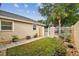 Landscaped side yard with pathway and gate at 13141 Palmilla Cir, Dade City, FL 33525