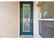 Dark teal front door with a glass panel at 13141 Palmilla Cir, Dade City, FL 33525