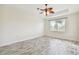 Bright bedroom with wood-look floors and large window at 13141 Palmilla Cir, Dade City, FL 33525
