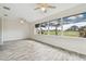 Bright living room with large windows and wood-look floors at 13141 Palmilla Cir, Dade City, FL 33525