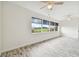 Bright living room with golf course view and wood-look tile floors at 13141 Palmilla Cir, Dade City, FL 33525