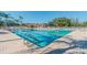 Community pool with a separate shallow area and surrounding patio at 13141 Palmilla Cir, Dade City, FL 33525