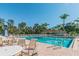 Sparkling community pool with surrounding patio and seating at 13141 Palmilla Cir, Dade City, FL 33525