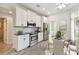 Modern kitchen with white cabinets, stainless steel appliances, and a breakfast nook at 13141 Palmilla Cir, Dade City, FL 33525