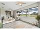 Living room with golf course views and ceiling fan at 13141 Palmilla Cir, Dade City, FL 33525