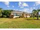 Tan house with brown shutters and manicured lawn at 13141 Palmilla Cir, Dade City, FL 33525