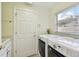 Laundry room with washer, dryer, and utility sink at 13141 Palmilla Cir, Dade City, FL 33525