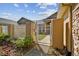 White gate leading to a pathway and courtyard at 13141 Palmilla Cir, Dade City, FL 33525