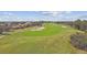 Aerial view of a golf course with houses nearby at 13141 Palmilla Cir, Dade City, FL 33525