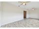 Open living room with wood-look tile floors and ceiling fan at 13141 Palmilla Cir, Dade City, FL 33525