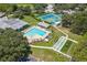 Aerial view of community pool, tennis courts, and pickleball courts at 13229 Golf Ridge Pl, Hudson, FL 34669
