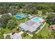 Aerial view of community pool, tennis courts, and clubhouse at 13229 Golf Ridge Pl, Hudson, FL 34669