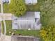 Aerial view of single-Gathering home with gray roof and landscaped yard at 13229 Golf Ridge Pl, Hudson, FL 34669