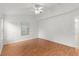 Simple bedroom with wood flooring and a ceiling fan at 13229 Golf Ridge Pl, Hudson, FL 34669