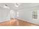 Well-lit bedroom with wood floors and access to bathroom at 13229 Golf Ridge Pl, Hudson, FL 34669