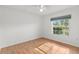 Spacious bedroom featuring wood floors and large window at 13229 Golf Ridge Pl, Hudson, FL 34669
