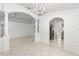 Dining room with tile floors and chandelier, open to living room at 13229 Golf Ridge Pl, Hudson, FL 34669
