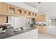 Modern kitchen featuring a breakfast bar and view to backyard at 13229 Golf Ridge Pl, Hudson, FL 34669