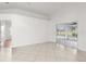 Spacious living room with tile floors and sliding glass doors at 13229 Golf Ridge Pl, Hudson, FL 34669