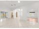 Open living area with tile floors and views to the kitchen at 13229 Golf Ridge Pl, Hudson, FL 34669