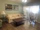 Living room with hardwood floors, neutral decor, and a rocking chair at 1601 Berwick Ct # B, Palm Harbor, FL 34684