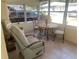 Bright and airy screened porch with seating and small table at 1601 Berwick Ct # B, Palm Harbor, FL 34684