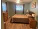 Spacious bedroom with wood-look floors and large window at 1601 Berwick Ct # B, Palm Harbor, FL 34684